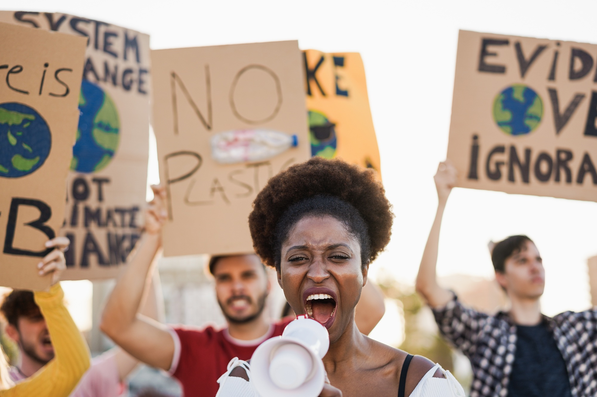 Young group of demonstrators on road from different culture and race fighting for climate change